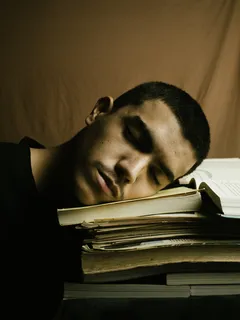 Hombre con camisa negra leyendo un libro